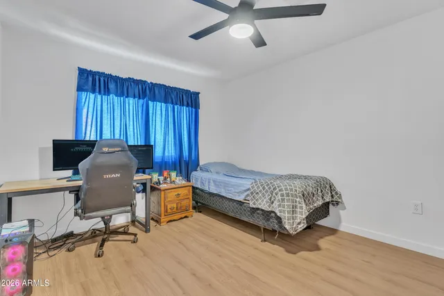 a bedroom with a bed and a chair