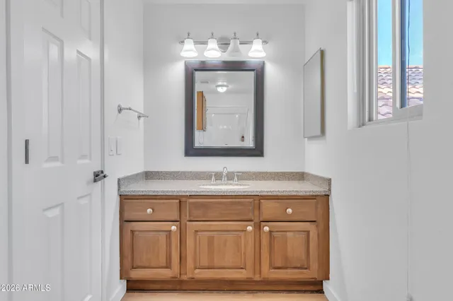 a bathroom with a sink vanity and mirror