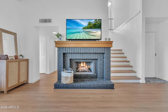 a living room with a fireplace and a fireplace