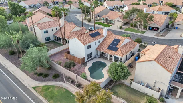 an aerial view of residential house with outdoor space and swimming pool