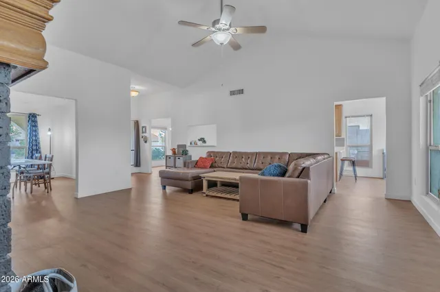 a living room with furniture and a wooden floor