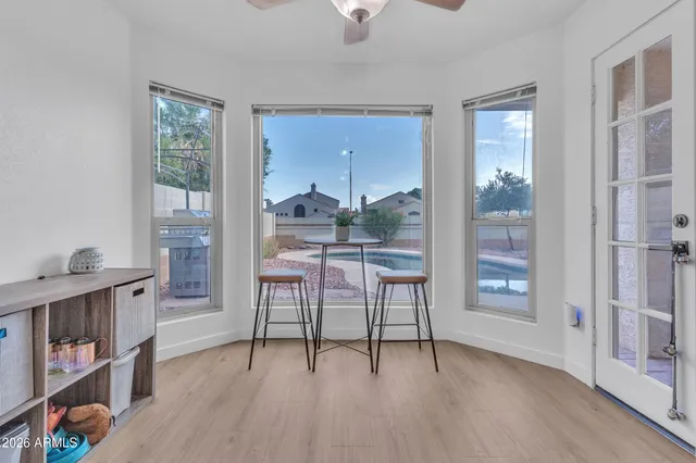 a dining room with furniture and a floor to ceiling window