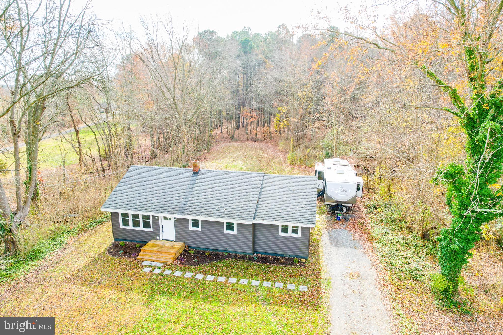 a view of a house with a yard and sitting area