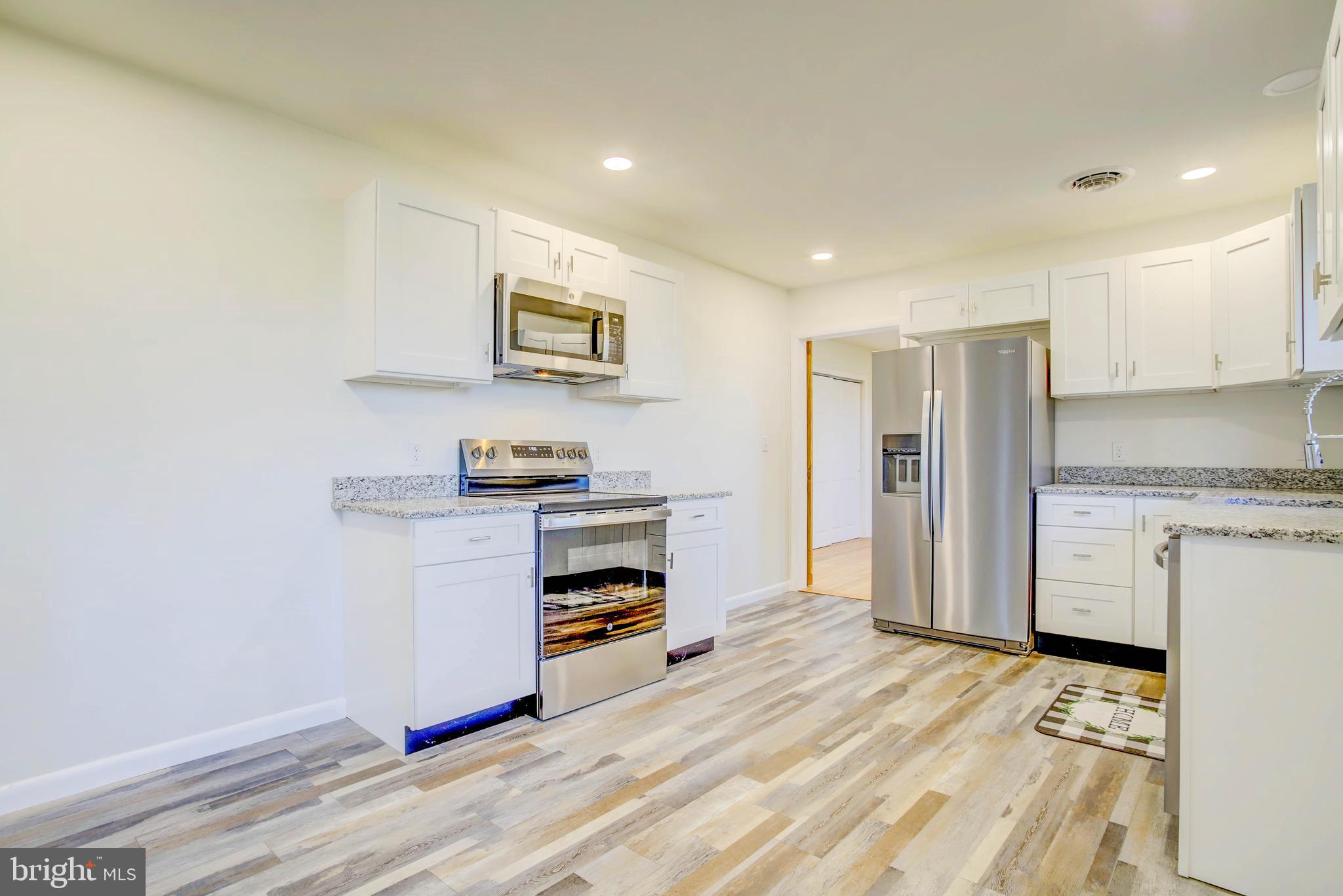 2229 Hudson Road Cambridge, MD 21613 - Photo 15 of 41 a kitchen with a refrigerator and a stove top oven