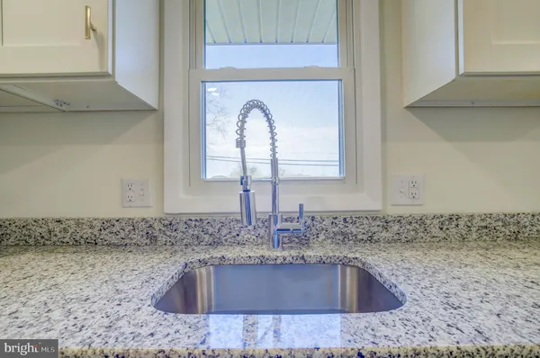 a kitchen with stainless steel appliances a stove and a microwave