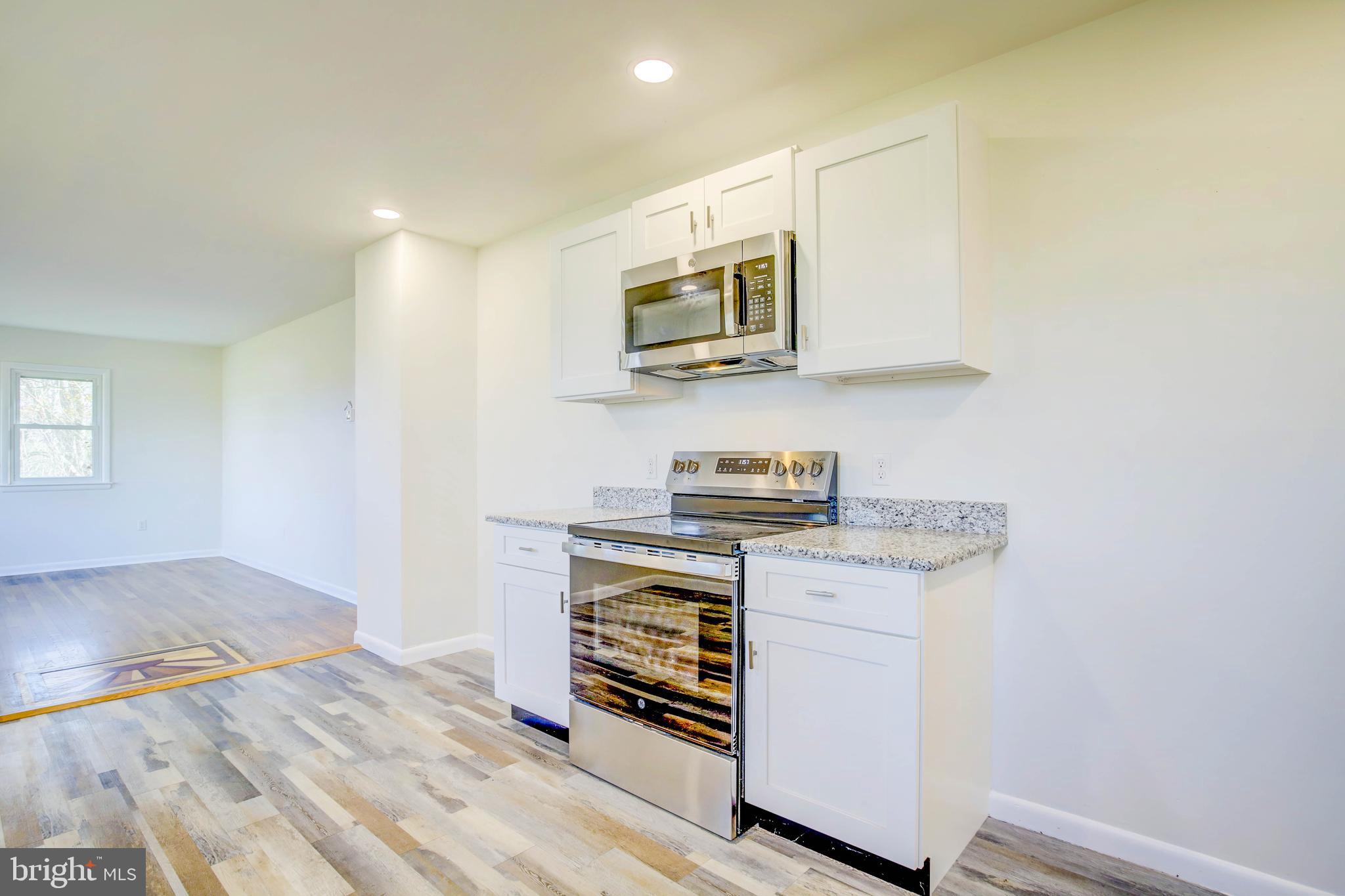 2229 Hudson Road Cambridge, MD 21613 - Photo 18 of 41 a kitchen with stainless steel appliances a stove and a microwave