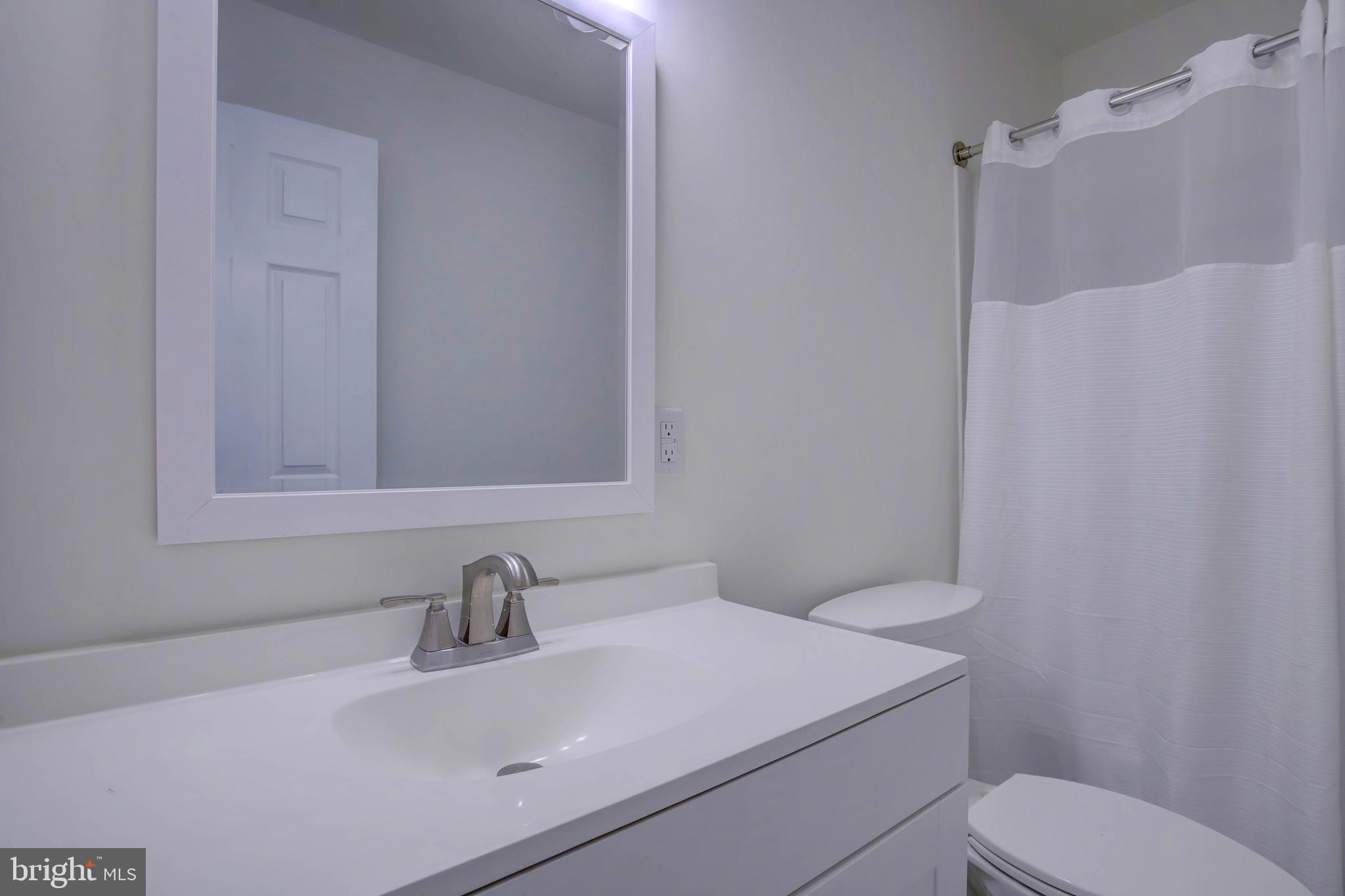 2229 Hudson Road Cambridge, MD 21613 - Photo 21 of 41 a bathroom with a sink a toilet and shower