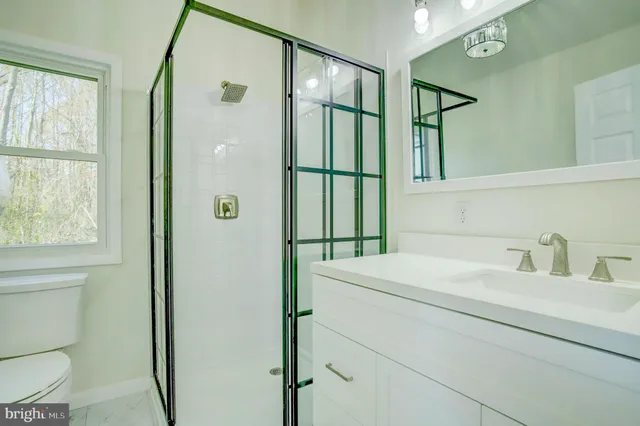 a bathroom with a sink a mirror and a shower