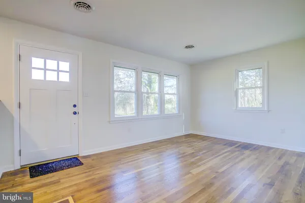 a view of wooden floor and windows in a room
