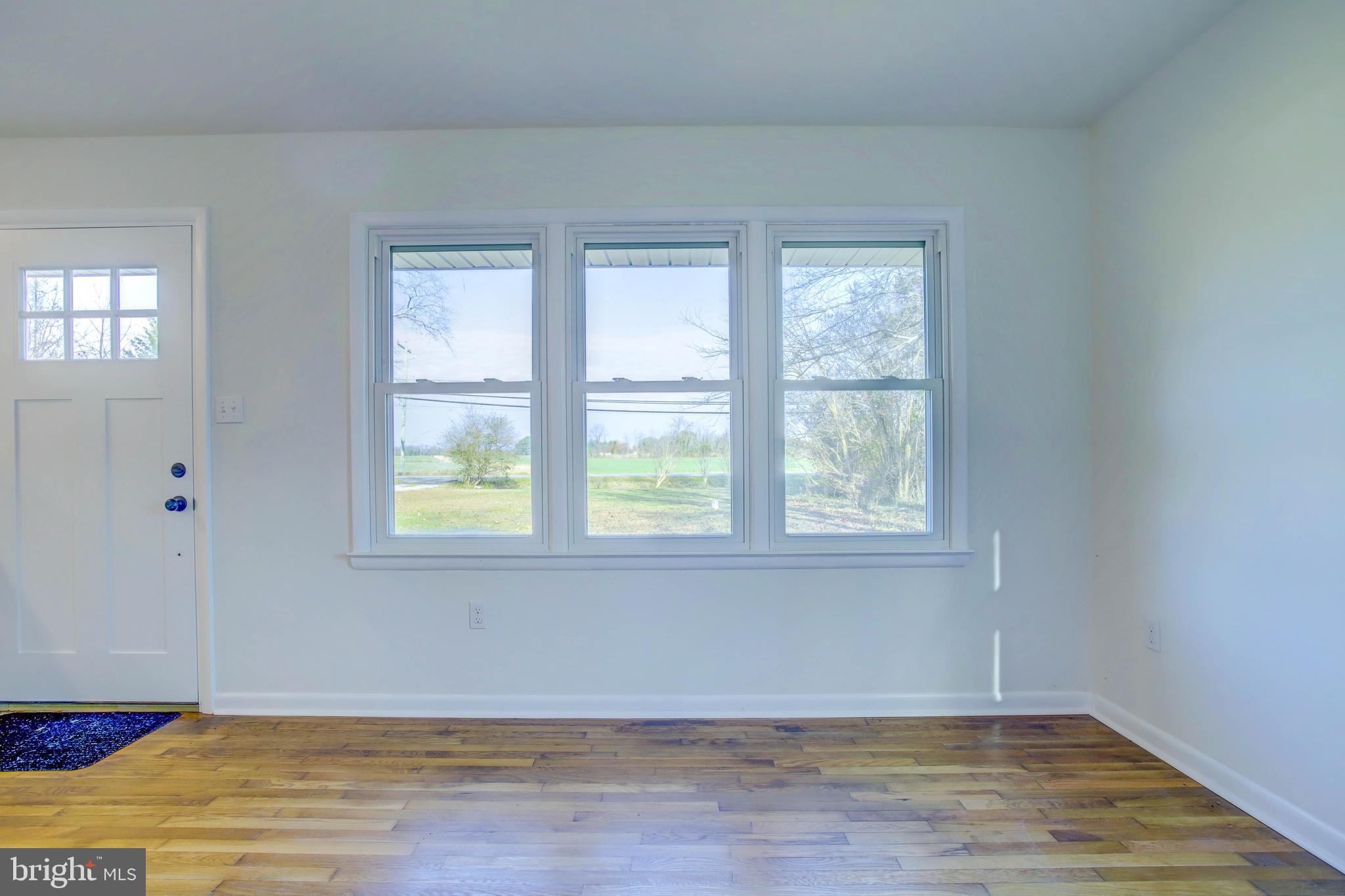 2229 Hudson Road Cambridge, MD 21613 - Photo 8 of 41 a view of an empty room with wooden floor and a window