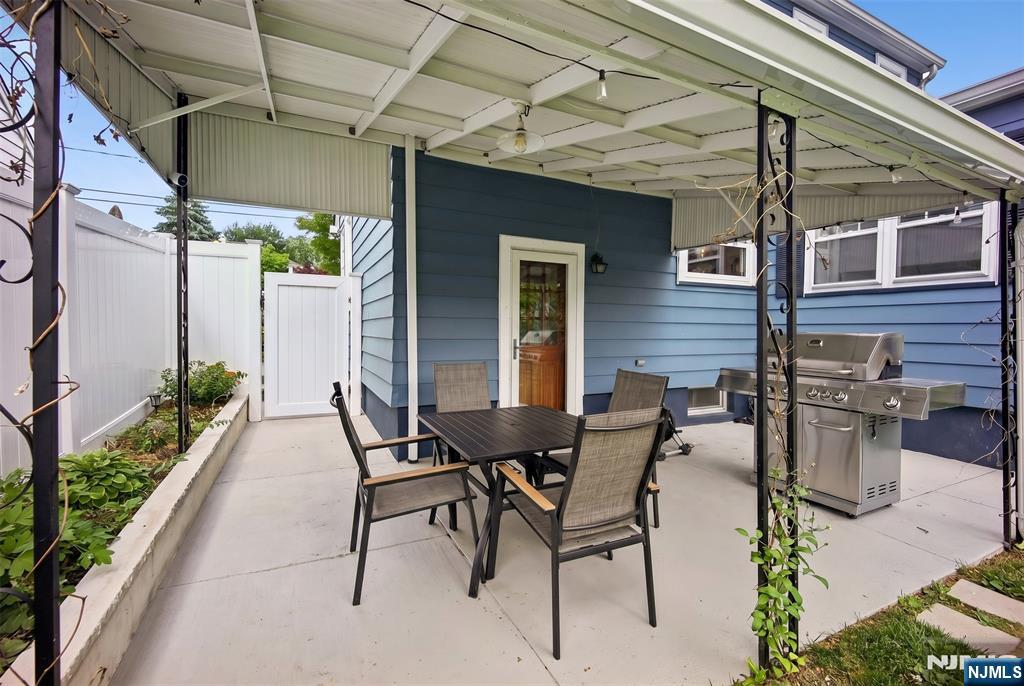 57 Oldis Street Rochelle Park, NJ 07662 - Photo 18 of 19 a view of a patio with table and chairs and potted plants