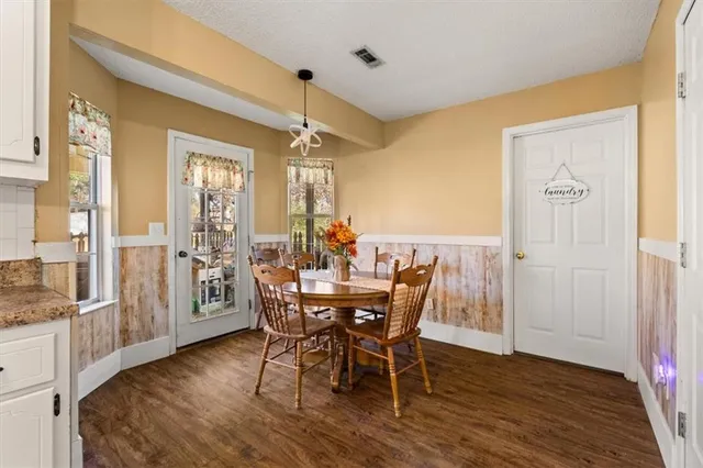a bedroom with furniture and a large window