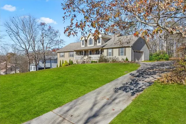 a front view of a house with a garden