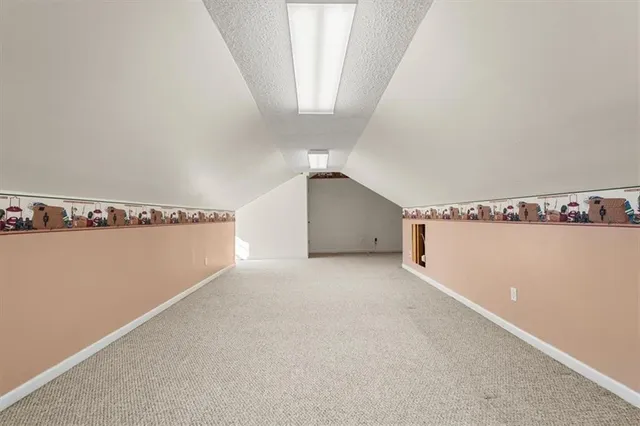 a view of an empty room with a ceiling fan