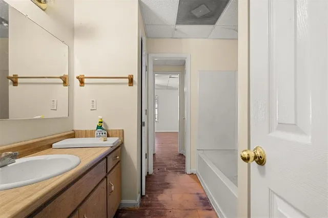 a view of a house with a big yard and large trees