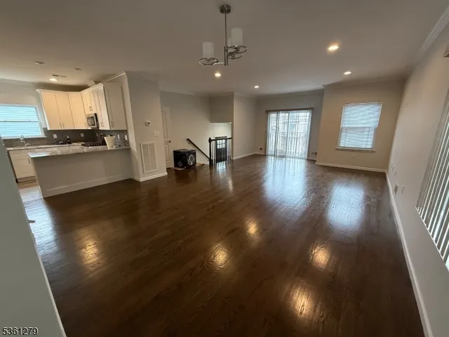 a view of a living room and kitchen with a large window