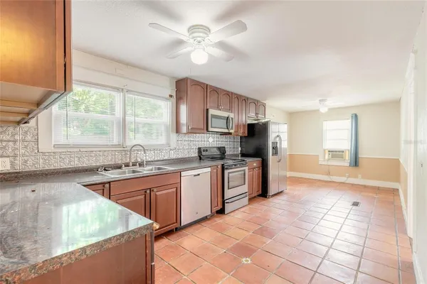 a large kitchen with cabinets and stainless steel appliances