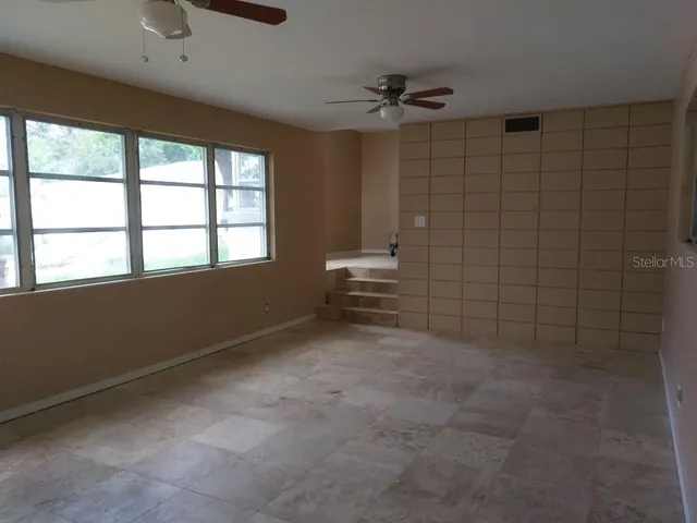a view of a house with pool porch and sitting area