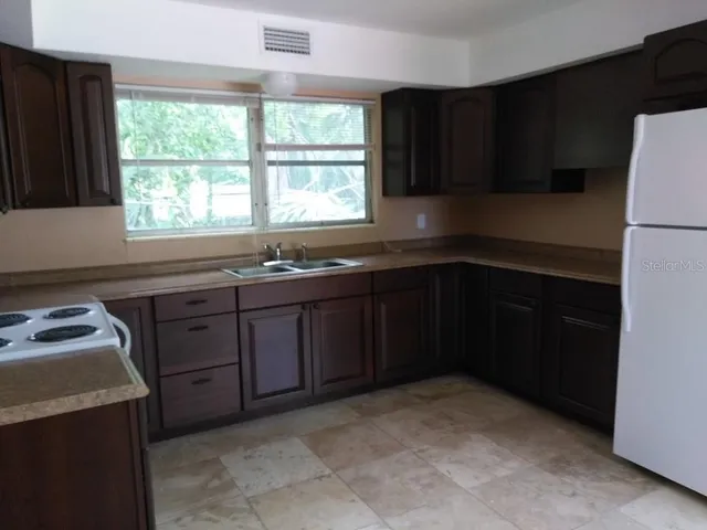 a view of a white house with a patio
