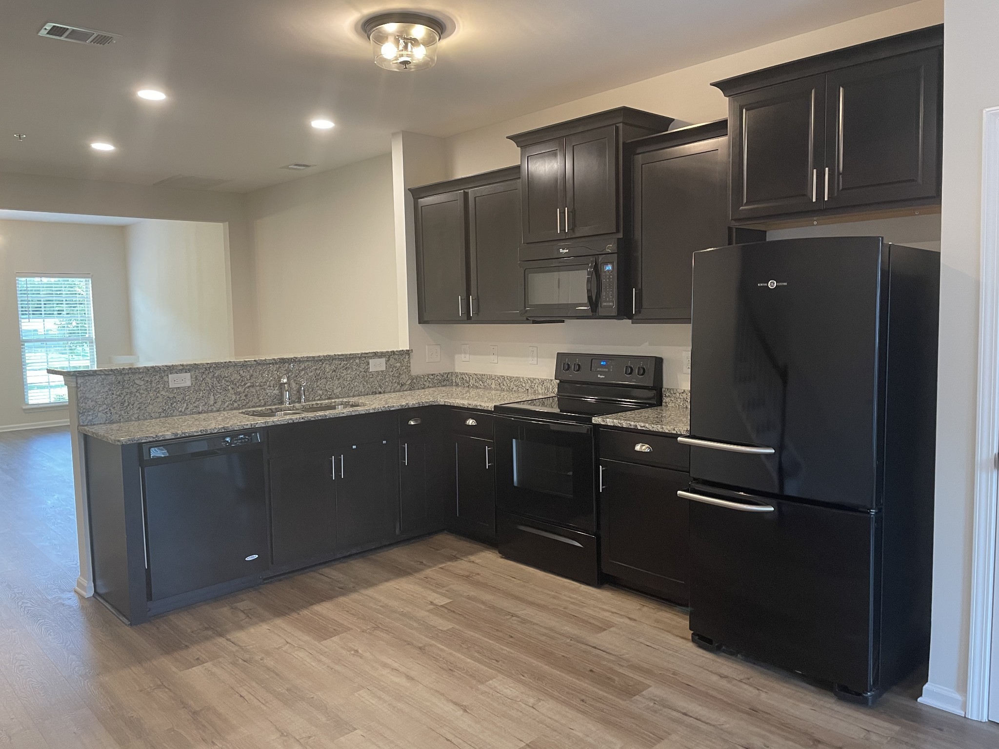 2083 Hemlock Drive Spring Hill, TN 37174 - Photo 11 of 30 a kitchen with granite countertop a refrigerator and a sink