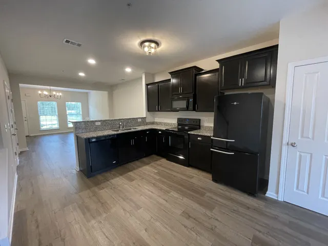 a kitchen with granite countertop stainless steel appliances and wooden cabinets