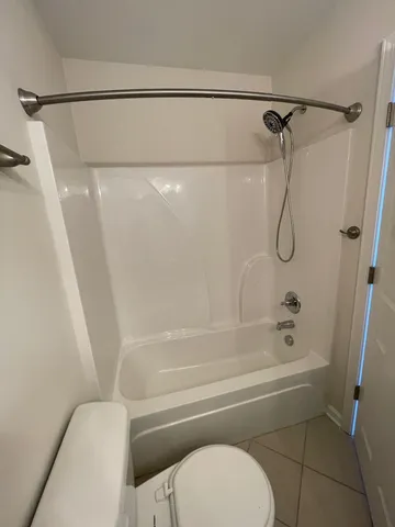 a bathroom with a shower and a toilet