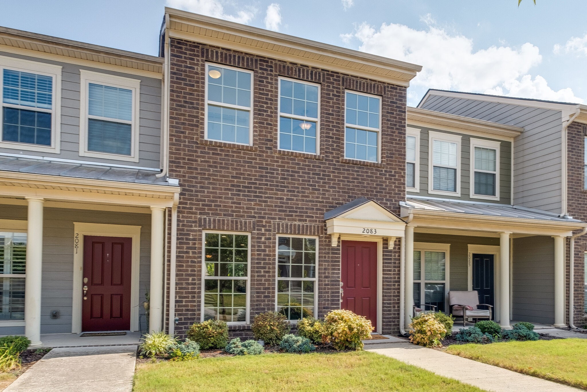 2083 Hemlock Drive Spring Hill, TN 37174 - Photo 2 of 30 front view of a brick house many windows and yard