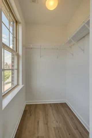 a view of a small space with wooden floor and windows