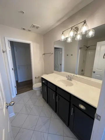 a spacious bathroom with a double vanity sink and a mirror