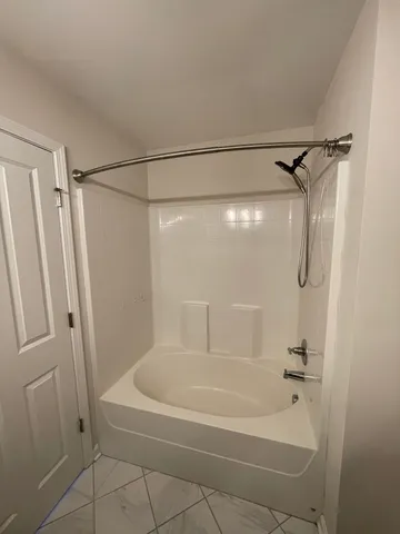 a bathroom with a shower and a bath tub