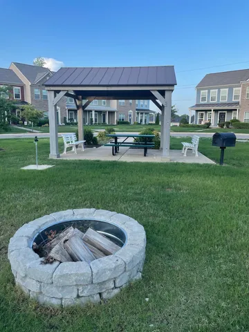 a view of a house with backyard sitting area and garden