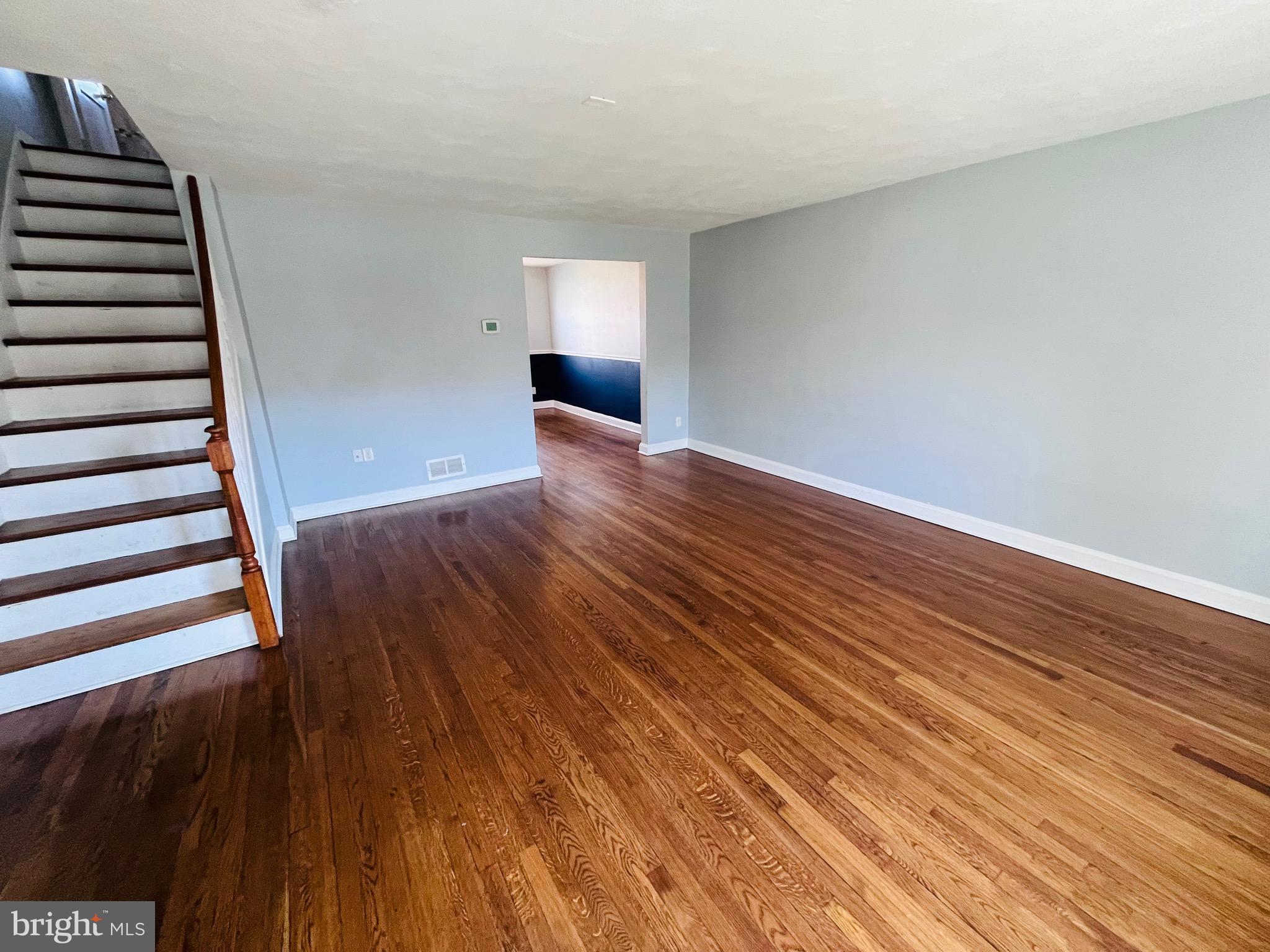 830 Arncliffe Road Baltimore, MD 21221 - Photo 4 of 12 wooden floor in an empty room with a window