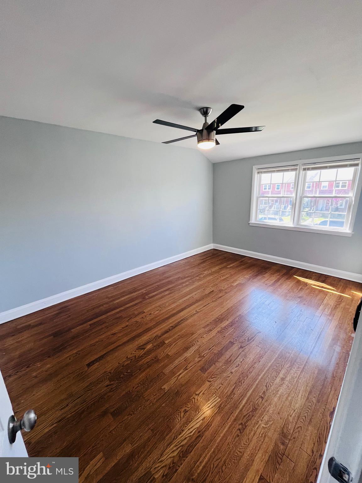 830 Arncliffe Road Baltimore, MD 21221 - Photo 6 of 12 a view of empty room with wooden floor and fan