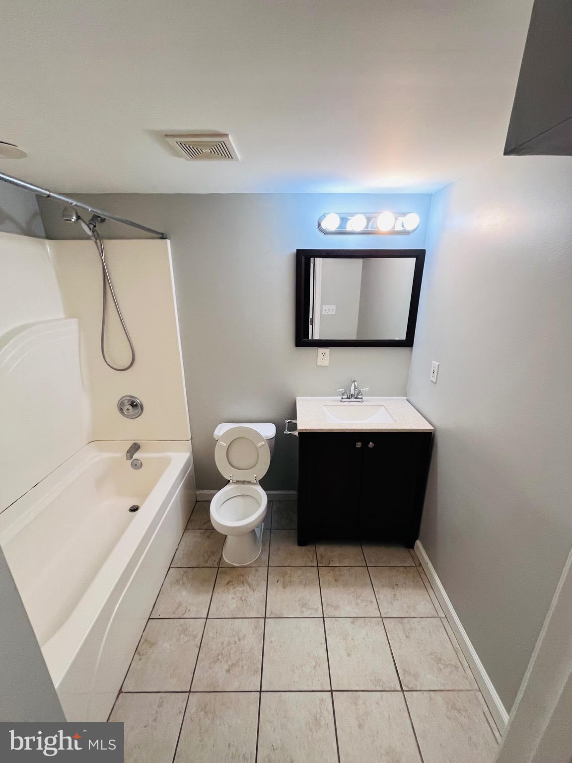 830 Arncliffe Road Baltimore, MD 21221 - Photo 9 of 12 a bathroom with a toilet a sink and bathtub