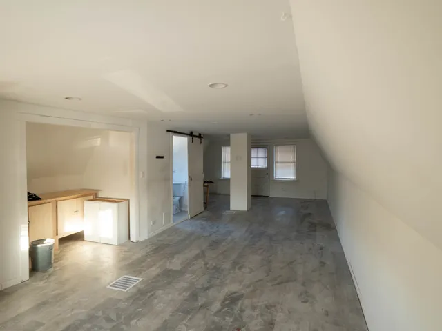 a view of a big room with closet and windows