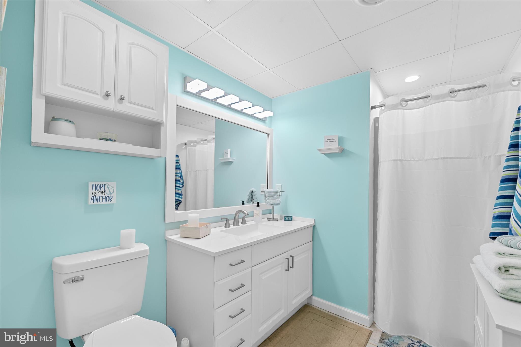 132 Jamestown Road, Unit 601 Ocean City, MD 21842 - Photo 20 of 37 a bathroom with a toilet sink and mirror