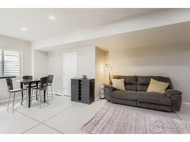 a living room with furniture and a dining table