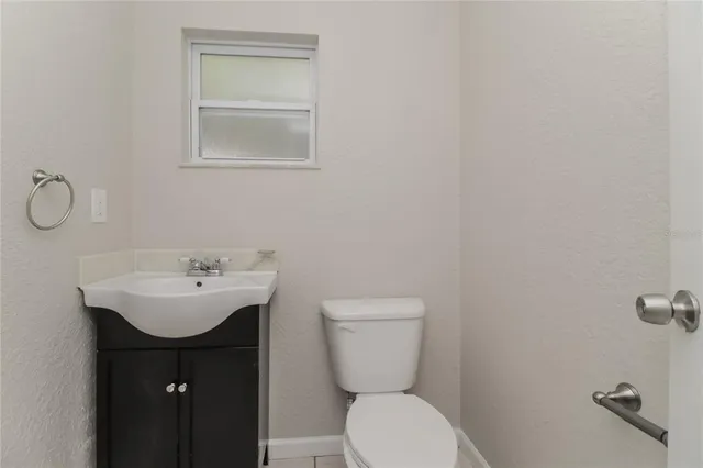 a bathroom with a sink a toilet and mirror