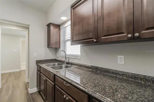 a kitchen with a sink and cabinets