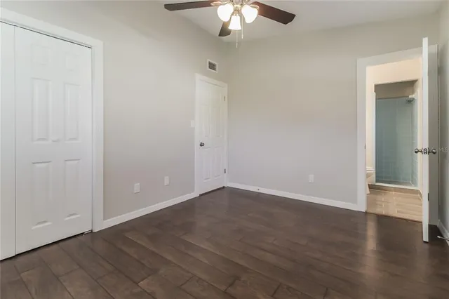 a view of an empty room with wooden floor