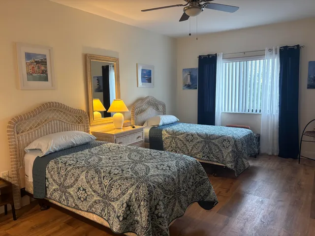 a bedroom with two beds and a chandelier