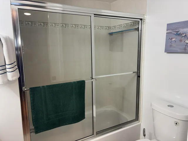 a bathroom with a glass shower door