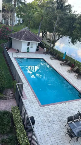 a view of a wooden deck and a backyard