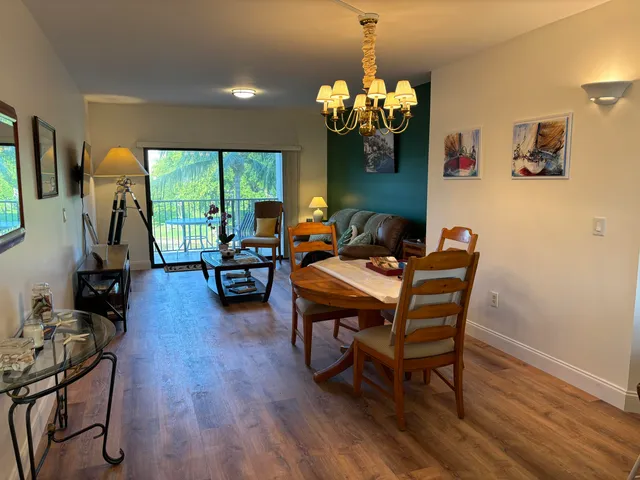 a living room with furniture a window and a chandelier