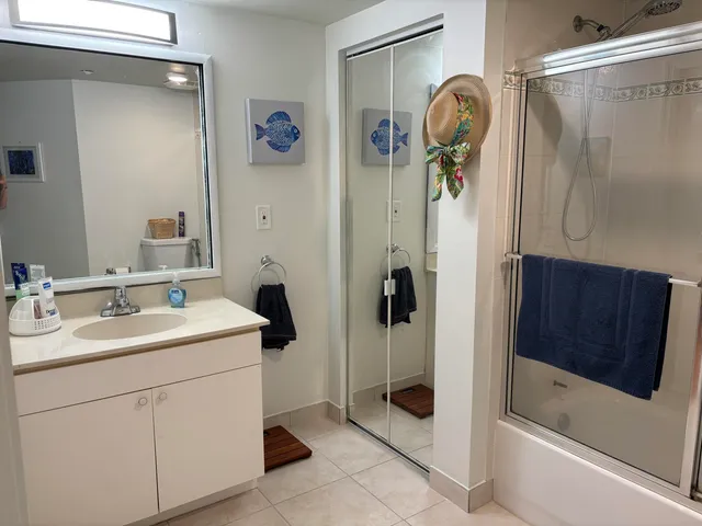 a bathroom with a sink a mirror and shower