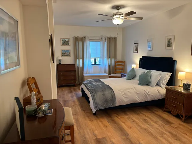 a bedroom with bed and a chandelier