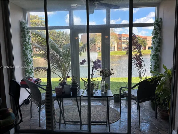a view of living room and patio from a balcony