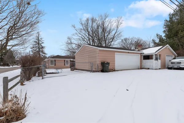 a front view of house with yard covered in snow