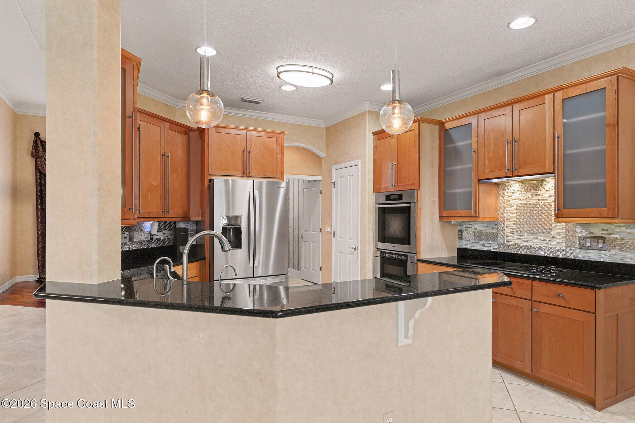 4325 Collingtree Drive Rockledge, FL 32955 - Photo 11 of 35 a kitchen with kitchen island granite countertop a sink stainless steel appliances and cabinets