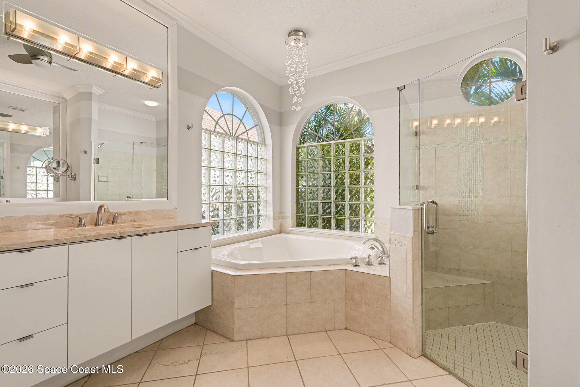 4325 Collingtree Drive Rockledge, FL 32955 - Photo 16 of 35 a bathroom with a granite countertop bathtub a sink and a large mirror